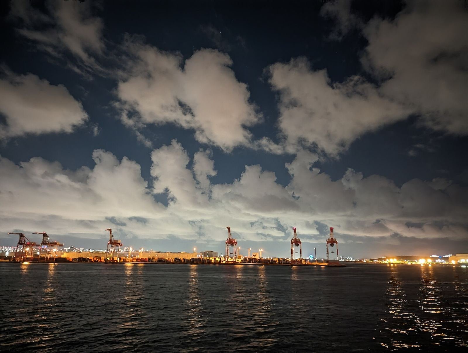 Container cranes at a port terminal at dusk